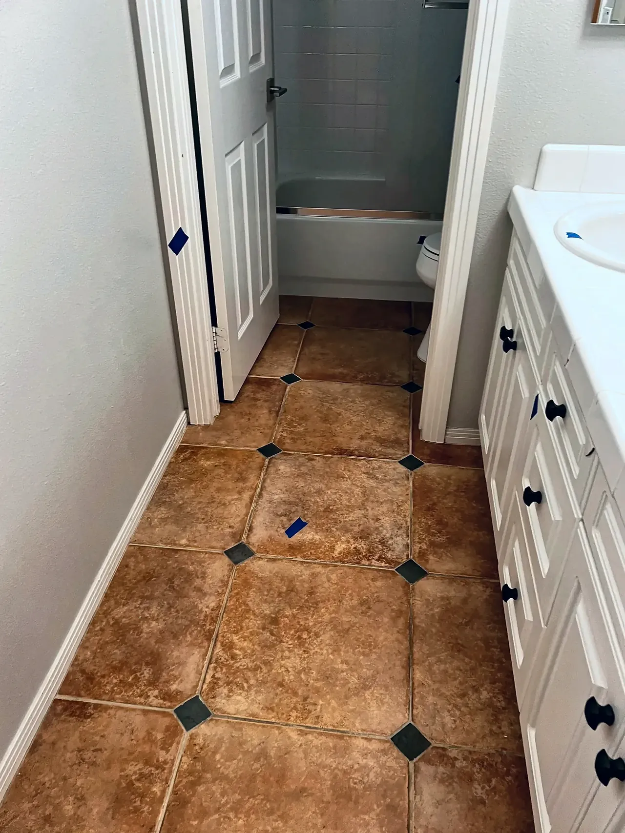 The hall bathroom before, with a tile-top vanity and a separate tub room