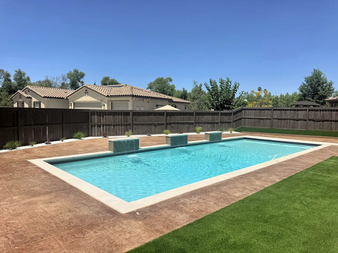 Pool, stamped concrete deck and artificial turf
