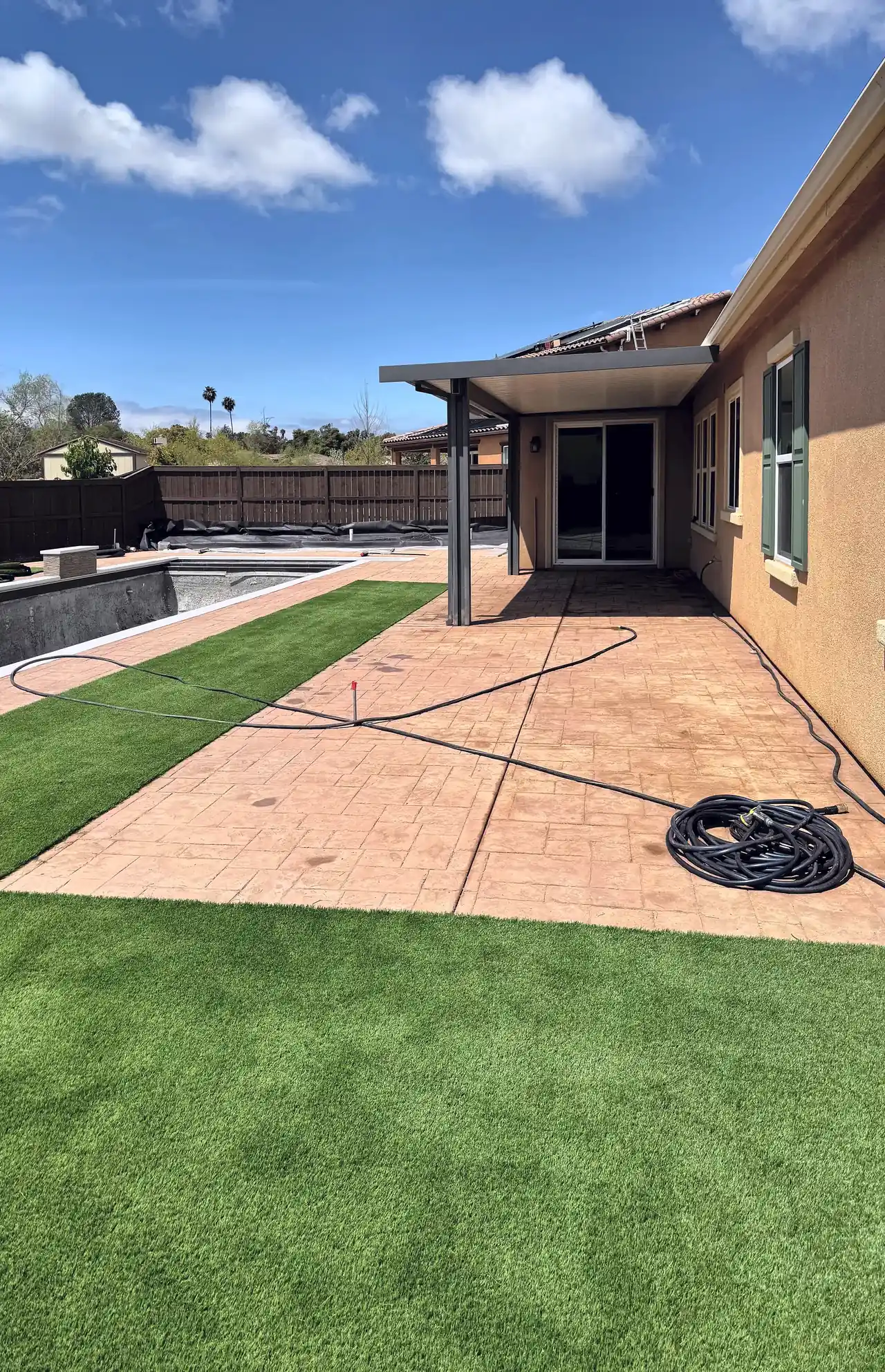 Artificial turf and the stamped concrete patio