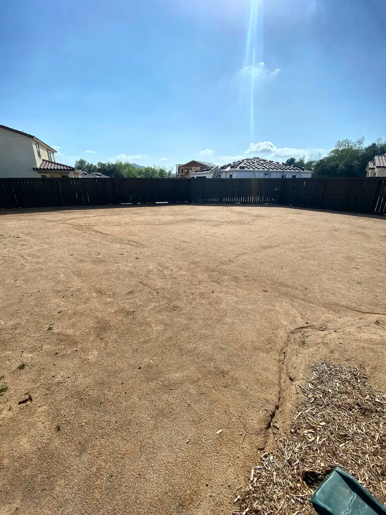The yard before: bare dirt behind a new house
