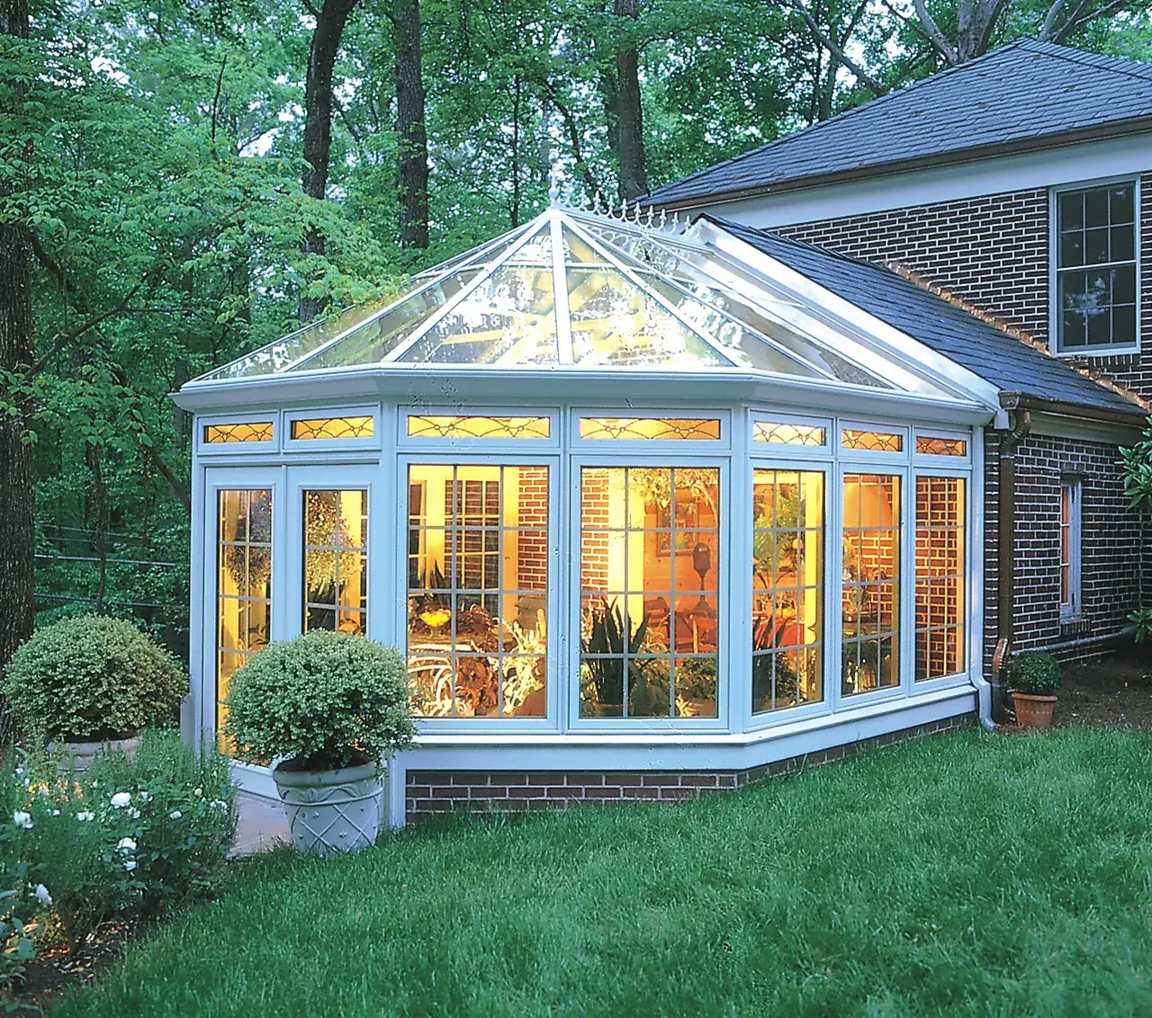 Four Seasons Victorian conservatory with white frames in a garden