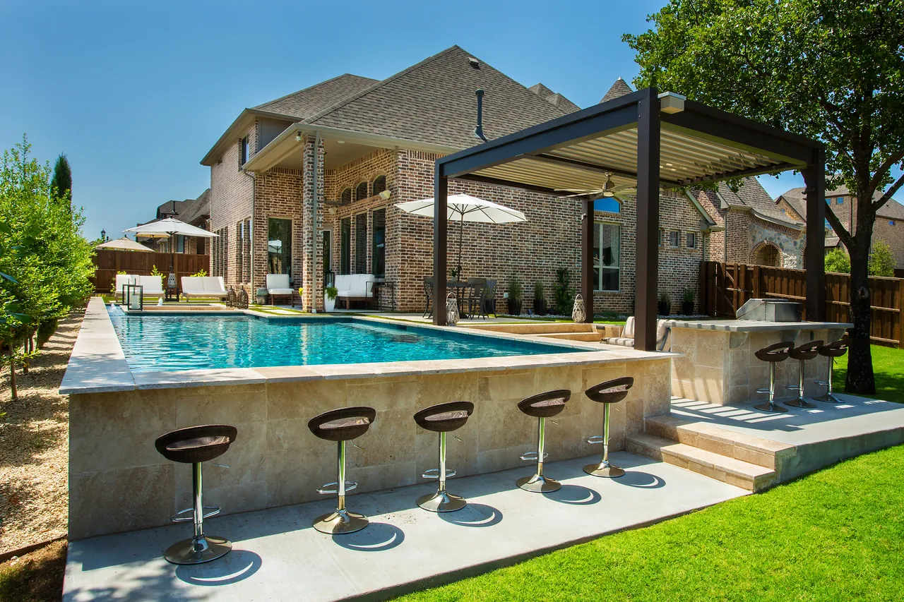 Dark Equinox louvered roof over a pool with a swim-up bar