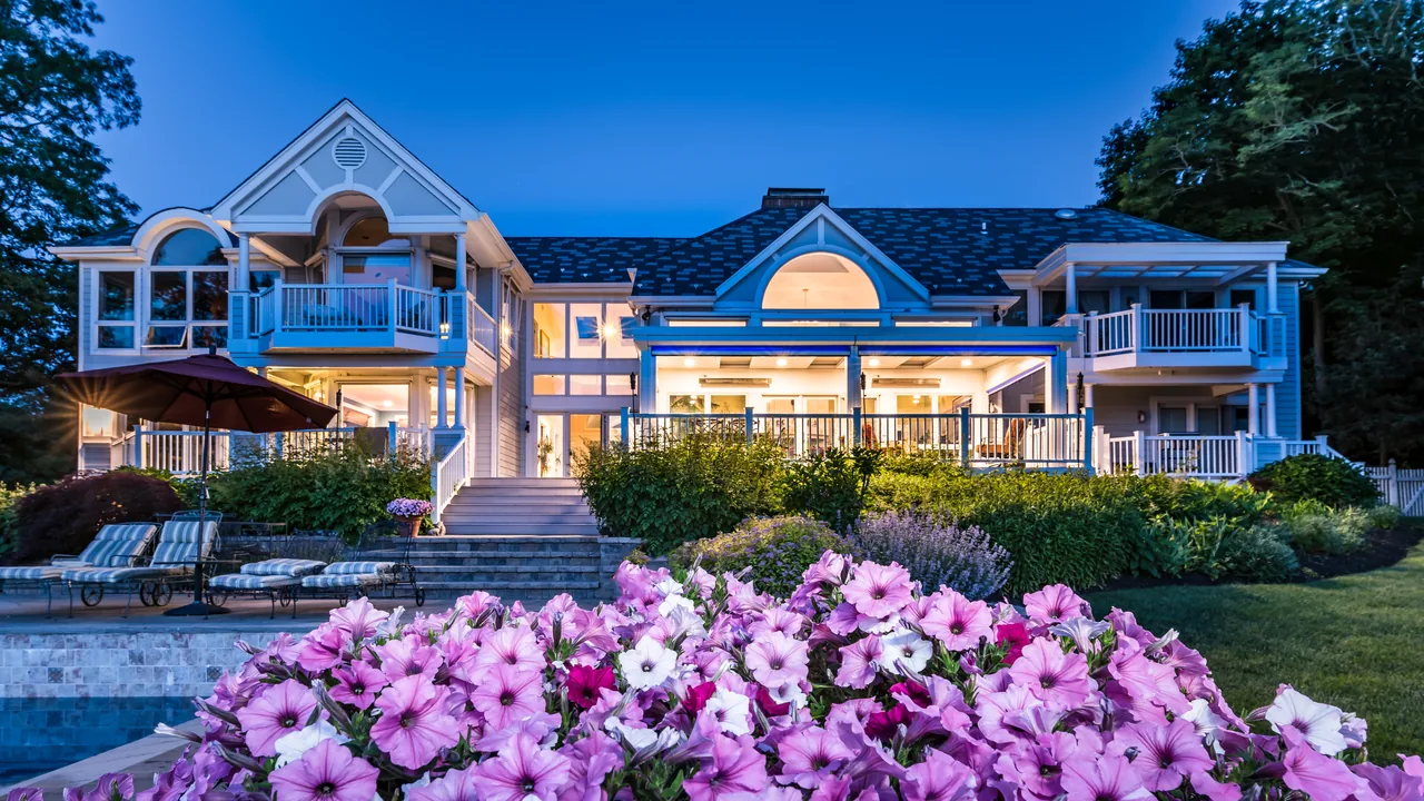 Four Seasons LifeRoom lit at night on the back of a large home