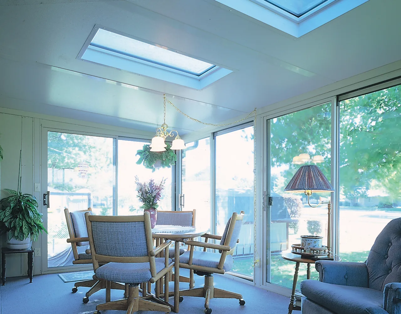 Four Seasons solid roof sunroom with skylights over a dining area
