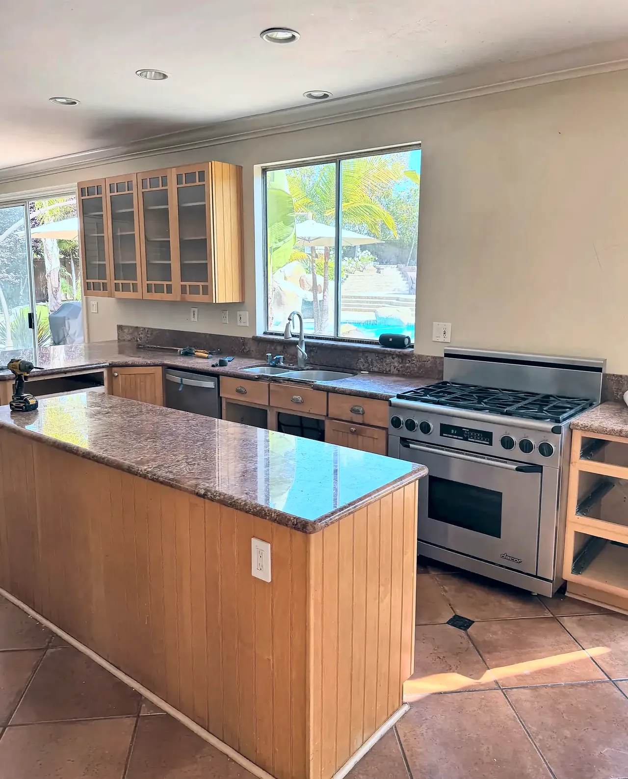 The kitchen before the remodel, with honey oak cabinets and brown granite