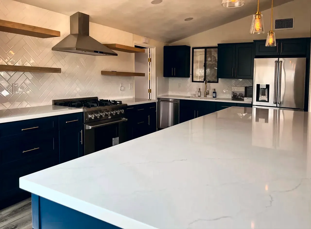 Navy shaker kitchen with a long quartz island in Serra Mesa