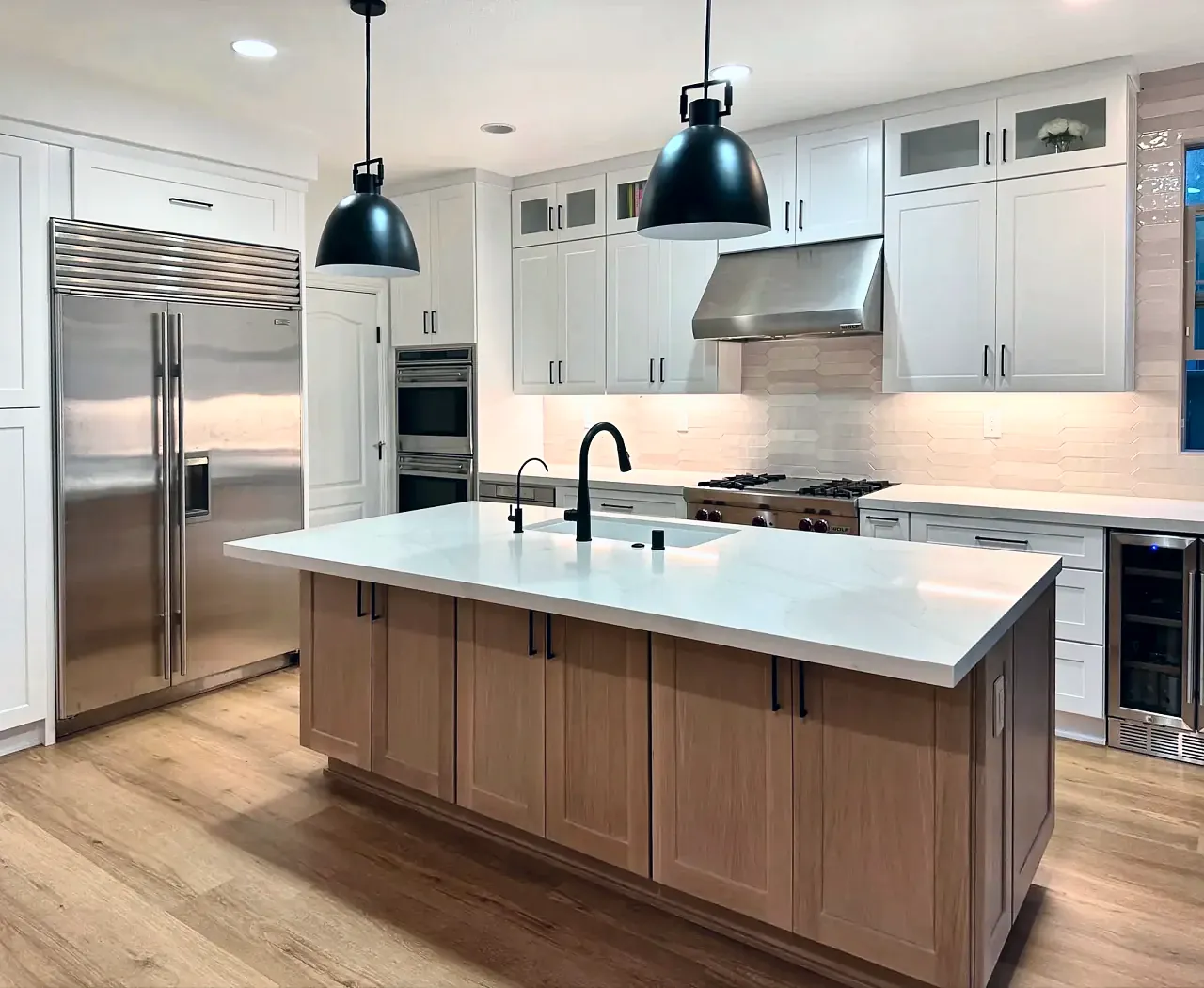 White shaker kitchen with a wood island