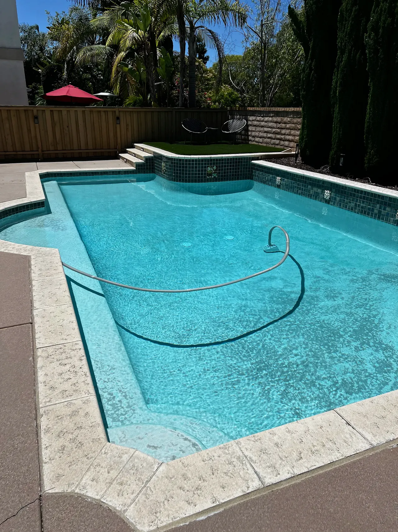 The pool before, with old white plaster and green waterline tile